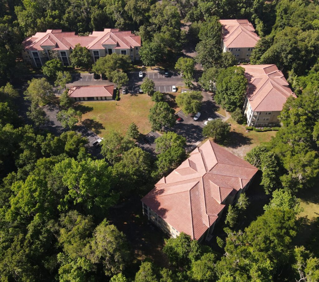 Aerial view of a terracotta tile roof surrounded by trees
