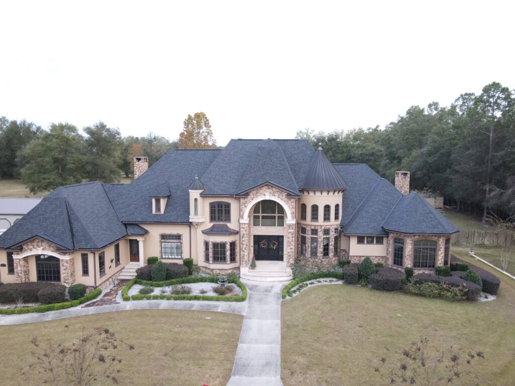 A large estate home with a finished architectural shingle roof