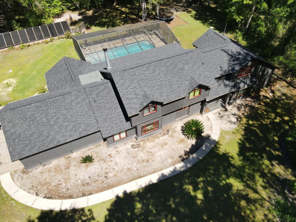 Aerial view of a finished dark shingle roof replacement by Retex Roofing