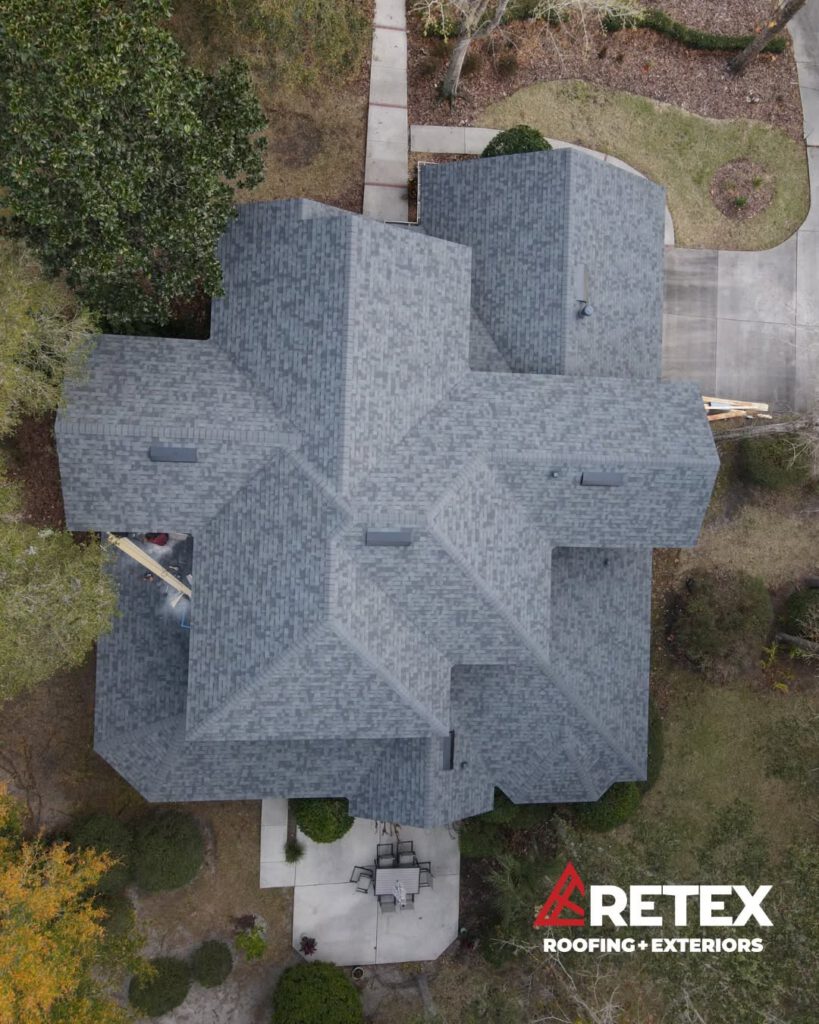 Aerial view of a complex grey shingle roof replacement