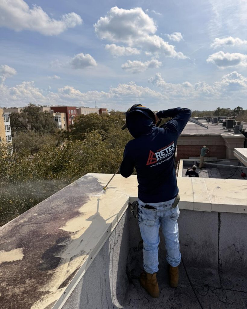 A Retex Roofing crew member working on a roof