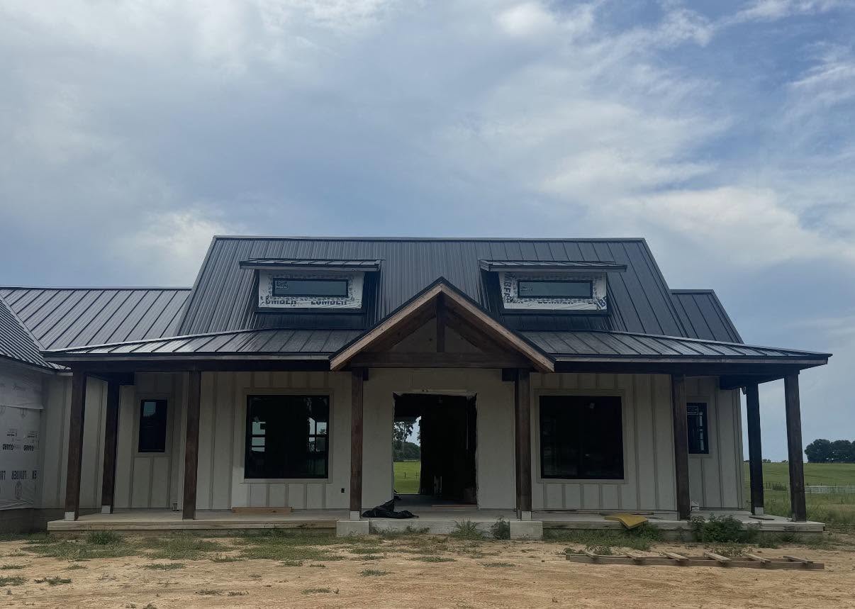 A newly replaced dark charcoal shingle roof, photographed the day the crew finished