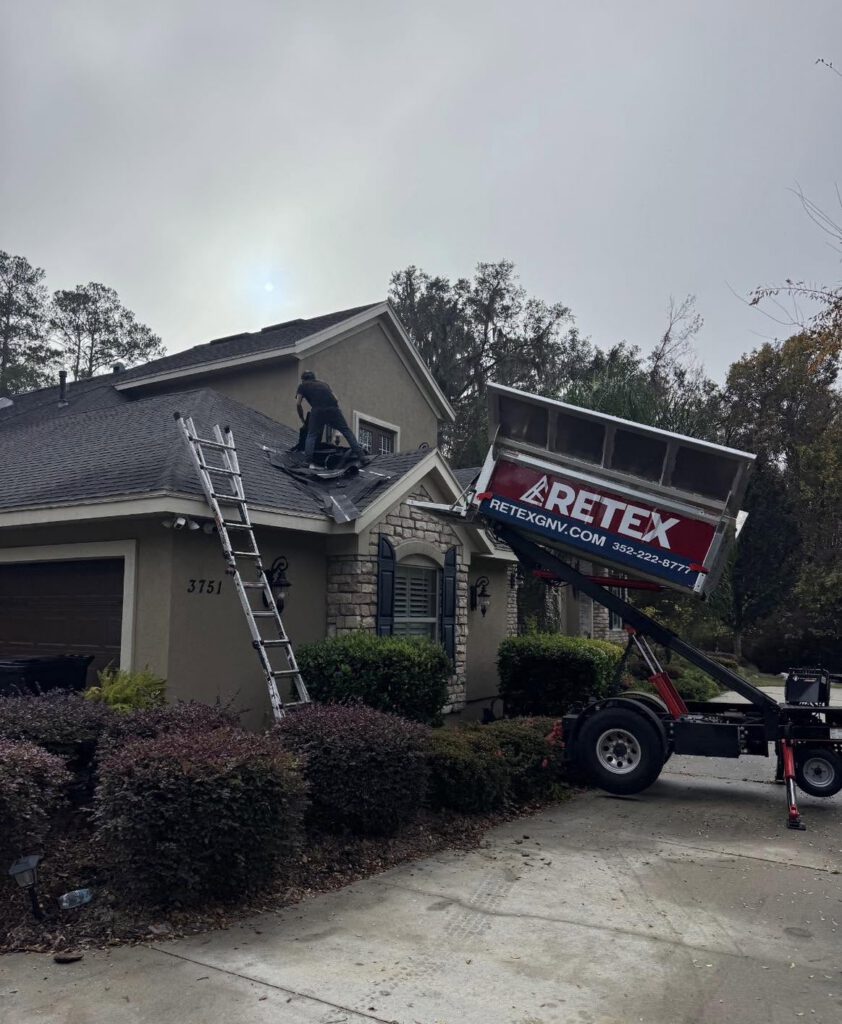 A Retex Roofing crew and trailer on site after a storm