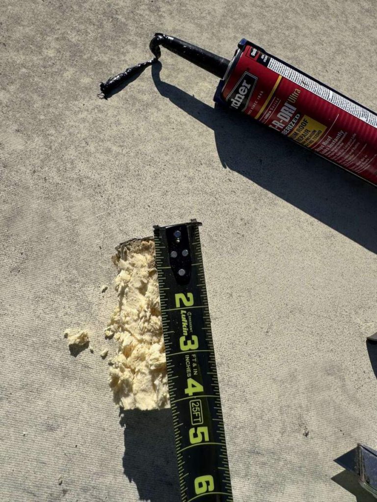 A tape measure laid against the foam core sample, reading roughly four inches of build-up